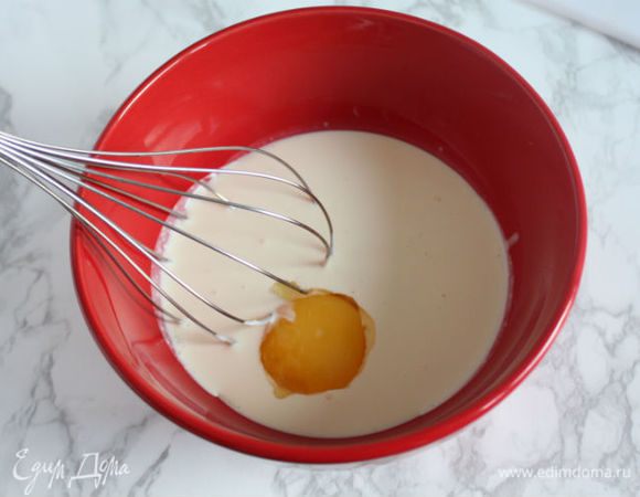В большую миску с крем-фреш поочередно введите желтки и перемешайте. 