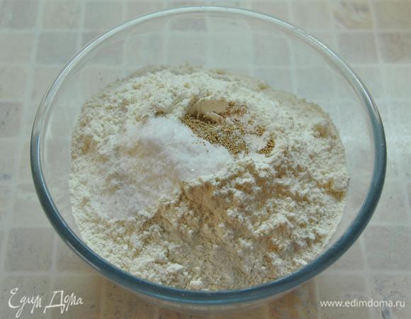 Чабатту можно (и нужно) готовить поэтапно. В ночь поставить тесто для брожения. Утром придать форму и испечь. Чабатта – это хлеб длительного брожения. На приготовление уходит не меньше 12 часов. Именно за время длительного брожения получается знаменитый мякиш чабатты – немного резиновый, упругий, с характерной «дырчатостью».
В небольшой миске смешать муку, дрожжи и хорошую полную чайную ложку соли (я взвесила, на всякий случай, у меня получилось 11 грамм соли). 