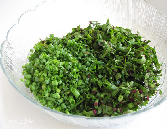 Удалить стебли и нарезать листья соломкой. Измельчить зеленый лук, перемешать с листьями.