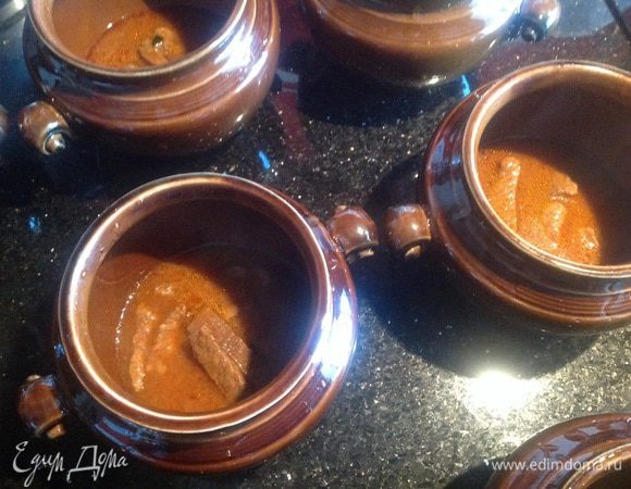 В подготовленные горшочки сначала выложите мясо вместе с соусом...