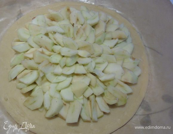 Яблоки очистите, нарежьте ломтиками. Разложите нарезанные яблоки кругами, отступив от края. С помощью ножа сделайте ободок вокруг яблок. 