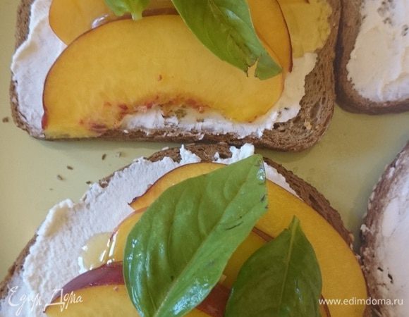 Выкладываем листики базилика и сверху накрываем вторым кусочком хлеба с рикоттой. Приятного аппетита.