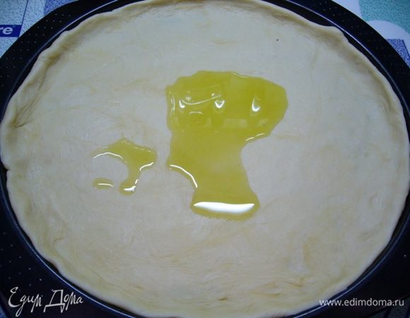 Духовку разогреть до 180 град.
Подошедшее тесто раскатать, выложить в смазанную маслом форму. 
Смазать поверхность 1 ст. л. оливкового масла.
