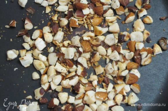 Крупные орехи разрезать пополам. Обжарить орехи на сухой сковороде. Отложить часть орехов для украшения.