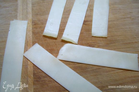 Я купила уже нарезанный слайсами полутвердый сыр «Гауда». Каждый ломтик разрезала на 4 полоски шириной 2 см, длиной 10 см.