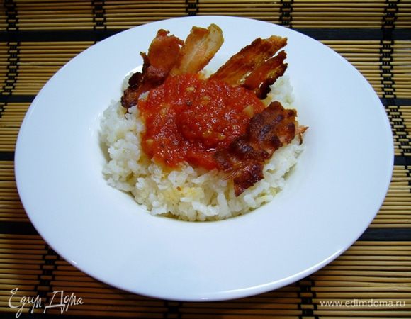 Подавать рис горячим, полив его соусом и украсив беконом.