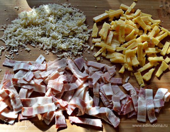 Тем временем порезать полосками бекон, сыр-гауда порезать брусочками, а пармезан натереть на мелкой тёрке.

