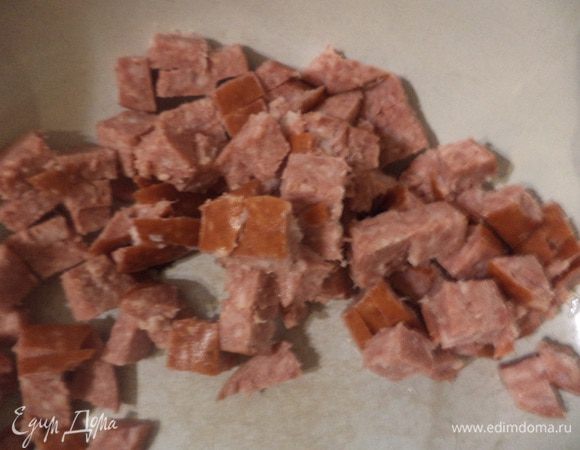 Консервированные помидоры откинуть на дуршлаг и слить с них сок.
Шампиньоны нарезать пластинками. Помидоры очистить от кожицы и нарезать кубиками. Ветчину или полукопчёную колбасу нарезать полосками.
Твёрдый сыр натереть на крупной тёрке.