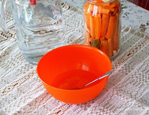 Когда морковка в банке уложена до верха, подготовим маринад. Для этого растворим в мисочке соль, сахар в небольшом количестве воды и добавим уксус. 