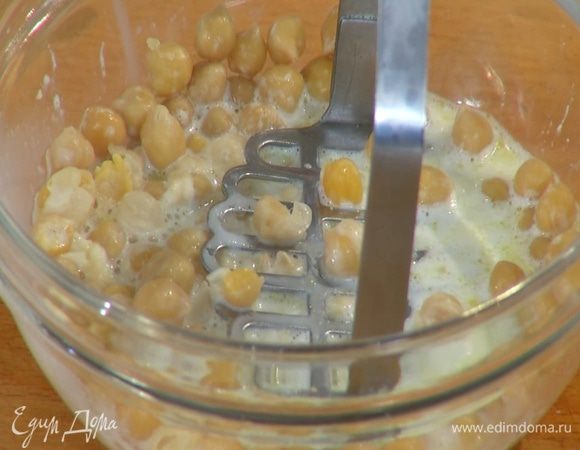 Нут вынуть из молока шумовкой и слегка размять толкушкой.