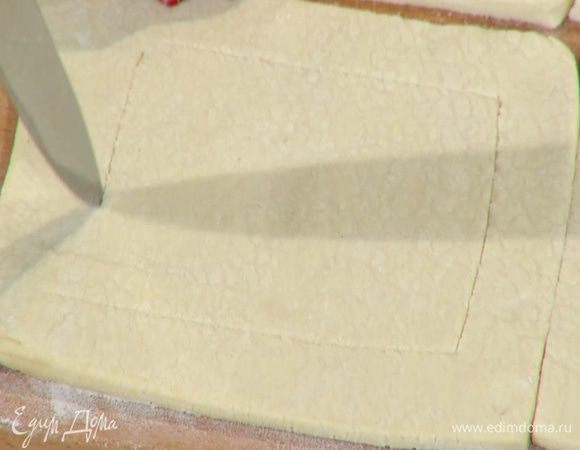 Отступая на 1 см от краев теста и не прорезая его насквозь, ножом прочертить квадраты меньшей площади, чтобы получились бортики.
