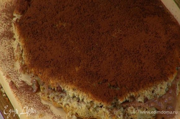 Нижнюю часть пирога смазать кремом, накрыть второй половиной и посыпать какао.