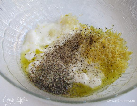 Приготовить маринад. Для этого смешать в емкости йогурт, оливковое масло, цедру лимона (натертую на мелкой терке), давленный чеснок, сухой орегано, соль и перец. Выдавить сок половины лимона.