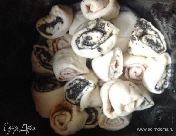 Далее все зависит от вашего желания и формы, в которой будете печь.
Если традиционно, то можно соединить рулеты концами и, разрезав каждый вдоль посередине (начинка наружу) переплести их между собой (так можно выложить сразу на смазанный противень или пергамент и выпекать).
Можно проделать те же самые манипуляции и свернуть переплетенные рулеты в кольцо, уложить в форму 22-24 см.
Мне же захотелось получить высокий "вулканьчик".
Для этого нужно рулеты нарезать на кусочки и выложить в смазанную маслом форму (у меня высокая, для пасок, 17 см в диаметре) хаотично, но при этом стараясь более-менее чередовать мак и корицу. Не старайтесь выкладывать рулетики ровно, а наоборот, как упадут (кто ровненько, кто боком) - так и хорошо.