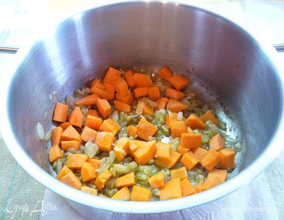 Добавляем морковь и обжариваем на сильном огне в течении 1 минуты, затем вливаем 4- 5 столовых ложек воды, доводим до кипения, делаем самый маленький огонь и при закрытой крышке тушим около 10 минут.