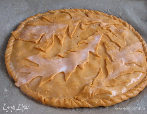 Тесто, которое мы оставляли для декора, раскатать и вырезать фигурки. В моем случае что–то вроде осенних листьев получилось. Можно, конечно, вообще без декора обойтись. Пирог смазать молоком и наколоть вилкой в нескольких местах для выхода пара. Поставить в духовку, разогретую до 200°C, на 25 минут.