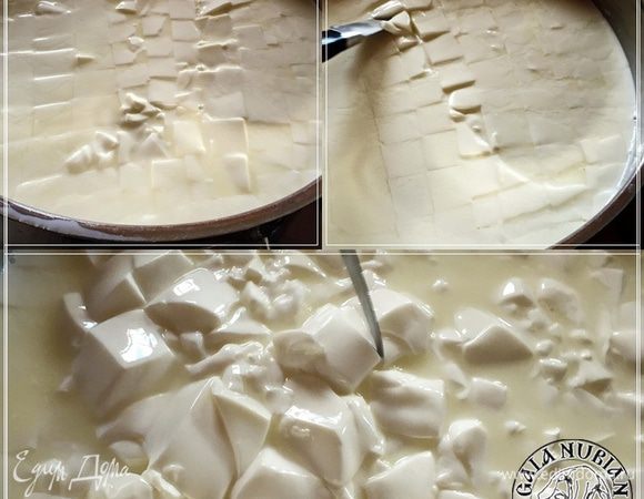 Мы делаем так: Нагреваем молоко до 38 градусов, добавляем липазу и термофильную закваску, даем постоять пару минут, чтобы порошки впитали влагу, а потом перемешиваем. Добавляем сычужный фермент и хлористый кальций, ждем сорок пять минут до образования сгустка при температуре 38 градусов.
Как только образовался плотный сгусток, режем его. Перемешиваем, подрезая сгусток.
