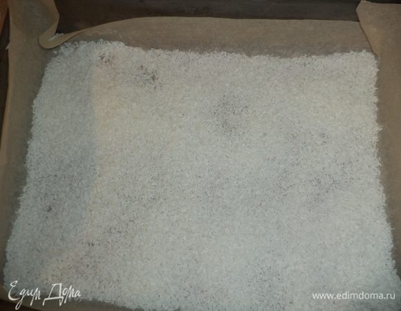 Квадратный противень выстелить бумагой для выпечки, посыпать 1/3 кокосовой стружки.