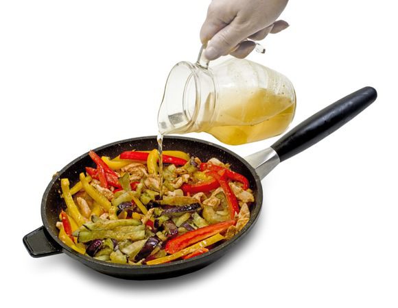 Баклажаны и перцы слегка панировать в крахмале и обжарить в масле. Выложить на бумажное полотенце и обсушить. Кусочки курицы быстро обжарить на сильном огне до золотистой корочки. Добавить чеснок, соевый соус, сахар, обжаренные баклажаны и перцы. Влить овощной бульон. Готовить до испарения жидкости.