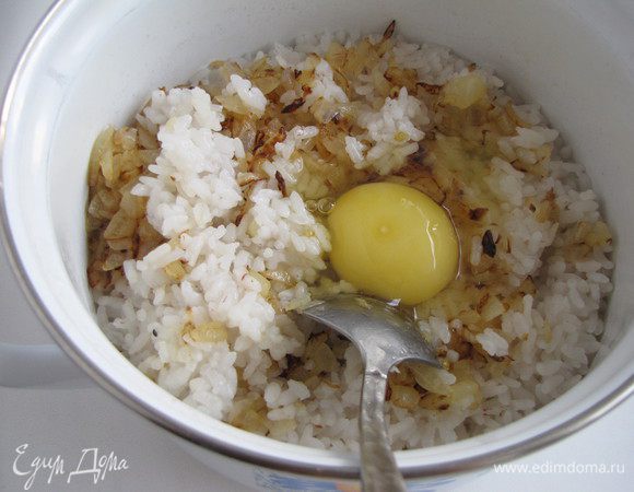 Отварить рис в подсоленной воде, можно это сделать заранее. Добавить к рису жареный лук и одно яйцо. Перемешать.