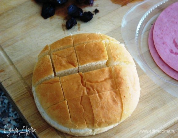 Теперь вооружаемся острым ножом и разрезаем нашу булку сверху "решеткой", немного не доходя до "дна". Она не должна развалиться!