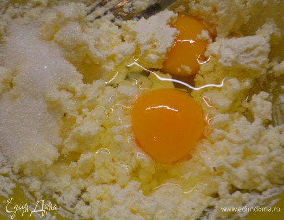 Творог размять вилкой. Я предпочитаю кремообразный, без крупинок. Разбить в миску яйца, всыпать сахар и ванильную эссенцию. Перемешать до однородности.