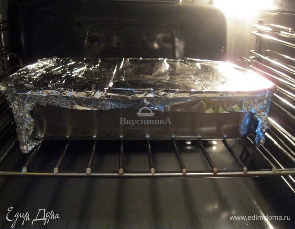 Сверху форму для запекания обвернуть фольгой. Запекать курицу с тыквой в духовке при температуре 180°C в течении 35 минут.