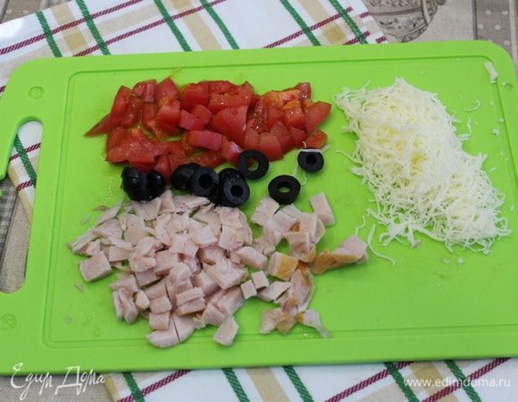 Сначала необходимо подготовить все для начинки. Куриную грудку нарезать на мелкие кубики, помидор и оливки мелко нарезать, сыр натереть на тёрке.