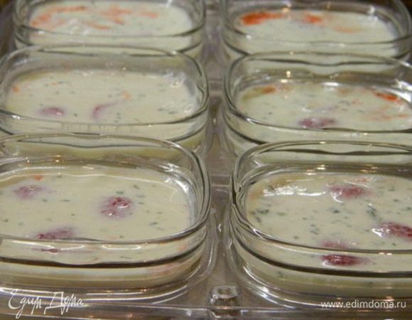 Сверху аккуратно разлейте молочную смесь.
Включить йогуртницу в сеть и поставить йогурт готовиться на 8 часов. По истечению времени закрыть баночки крышками и убрать в холодильник. Чем дольше он стоит, тем гуще он становится.