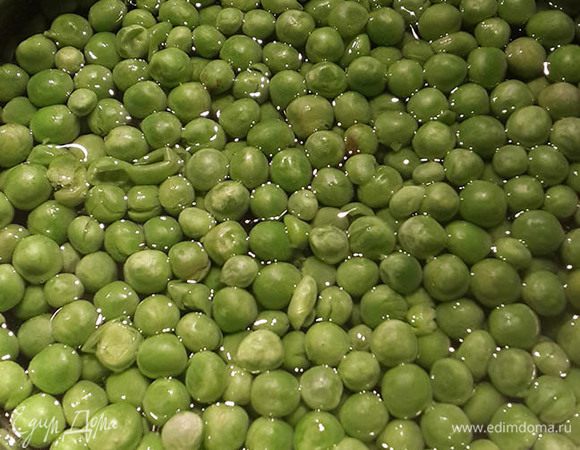 Зеленый горошек опустить в кипящую воду и варить около 2-3 минут.