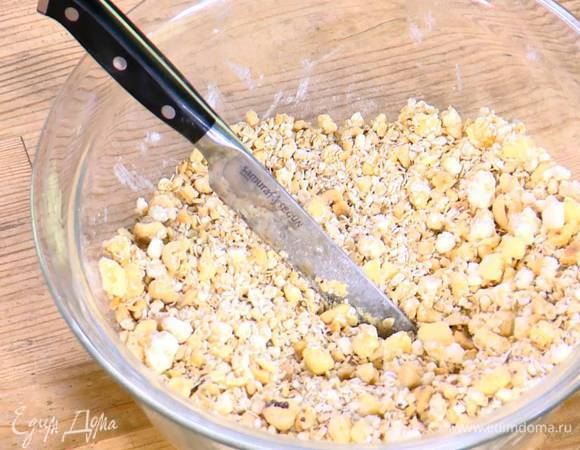 Приготовить тесто: сливочное масло соединить с творогом, мукой, сахаром и солью, все порубить ножом в крошку, затем добавить овсяные хлопья, фундук и порубить еще немного.