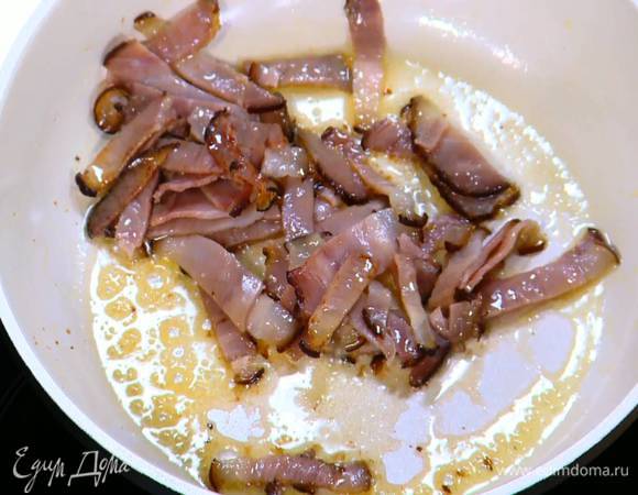 Разогреть в сковороде немного оливкового масла и обжарить грудинку.