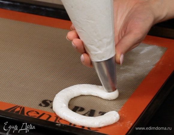 Переложите массу в кондитерский мешок и отсадите на пекарскую бумагу круги нужного размера. 