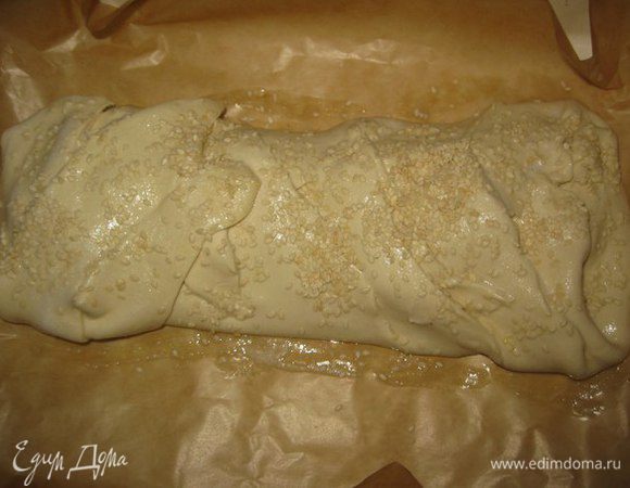 Рулет выкладываем на противень, на пекарскую бумагу. Смазать взбитым яйцом. Посыпать кунжутом.