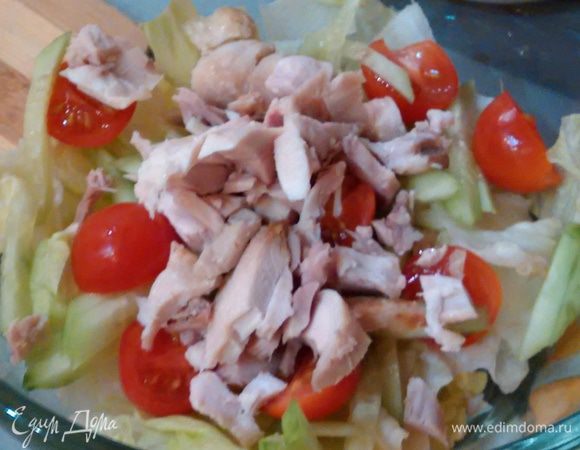 В салатник выложить половину салата, затем половину огурца, помидоров и курицы. Повторить все слои. Сверху посыпать рубленой зеленью.