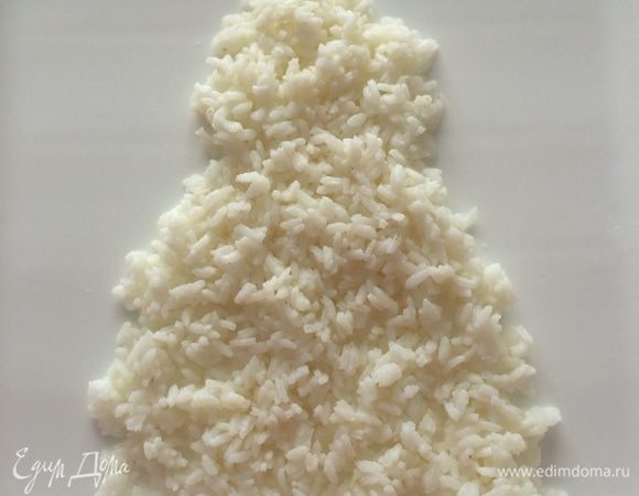 Выкладываем салат слоями в виде Деда Мороза:
Первый слой — вареный рис (варим рис в чуть подсоленной воде, затем остужаем), обмазываем майонезом по вкусу.