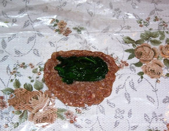 Ближе к верхнему краю лепешки выложите шпинатную начинку. Немного загните край лепешки на себя. 