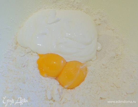 Добавляем желтки и сметану.