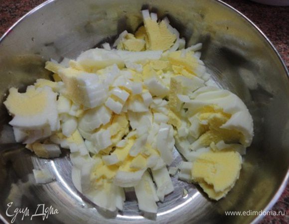 Готовые яйца остудить, почистить и нарезать кубиками.