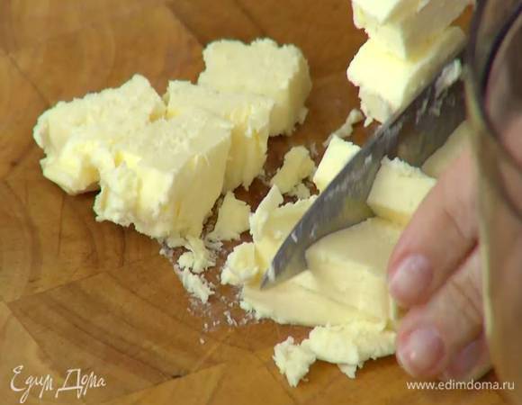 Предварительно охлажденное сливочное масло нарезать небольшими кусочками.