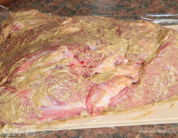 Переворачиваем мясо на подготовленную пищевую пленку и обмазываем маринадом другую сторону мясного куска.