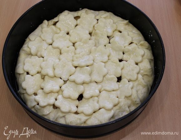 Цветочки разложить произвольно сверху пирога, смазать молоком.