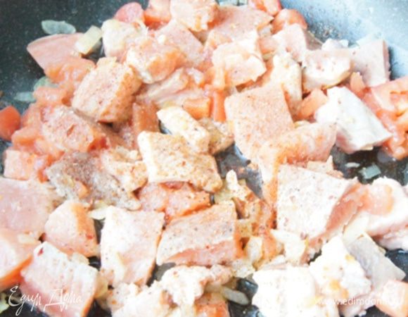 Добавить в сковороду кусочки рыбы, нарезанный кубиками помидор (кожицу лучше снять). Посолить и добавить смесь перцев. Если помидор не сочный, добавьте пару ложек воды. Готовить до готовности рыбки, у меня ушло 5-7 минут.