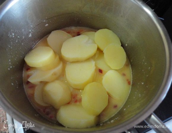 Добавить масло и выложить картофель. Осторожно перемешать.