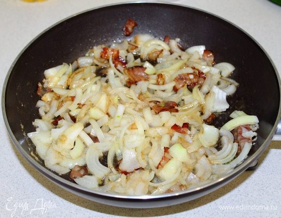 Лук нарезать полукольцами, добавить к бекону, всыпать сахар и немного соли. Тушить все вместе до мягкости лука.