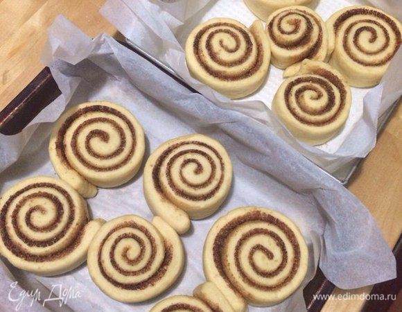 Режем пилящими движениями, не прижимая тесто сильно на 11-12 кусочков.
Кладем на противень, застеленный бумагой для выпечки, и сверху кладем лист бумаги и оставляем на один час подходить! 
Выпекаем булочки в предварительно разогретой духовке при 190°C 25 минут.