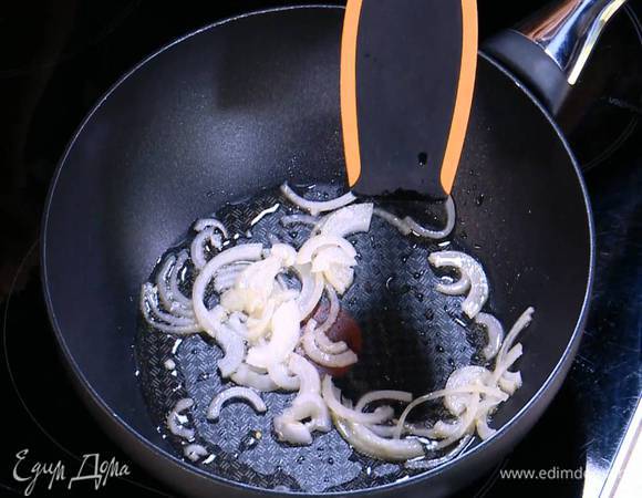 Разогреть в сковороде вок 1 ст. ложку оливкового масла и обжарить лук.