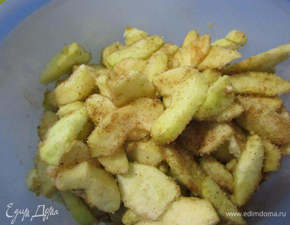 Этим временем подготовить начинку. Яблоки помыть, почистить от кожуры и семечек. Нарезать тонкими пластинками. Посыпать сахаром и корицей. Перемешать.