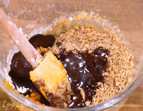 В тесто добавить измельченные орехи, цедру апельсина и растопленный со сливками шоколад.