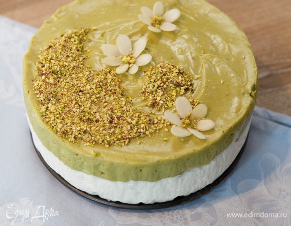 Приступим к украшению. Аккуратно откройте форму и снимите пекарскую бумагу. Подготовьте трафарет. Я вырезала из картона. Очистите фисташки и измельчите в крошку. Через трафарет нанесите рисунок. Цветы выложите из миндальных лепестков.